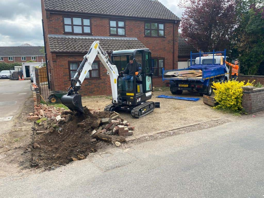 This is a photo of an operative of Earls Barton Driveways Digging out for a new tarmac driveway